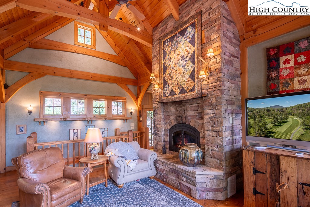 138 Mulberry Lane Boone, NC 28607 - Photo 5 of 33 a living room with furniture a fireplace and a flat screen tv