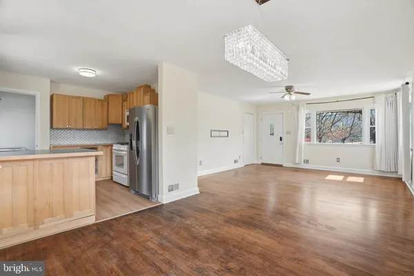 a view of a kitchen with a sink and a refrigerator