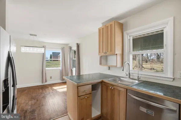 a kitchen with granite countertop a sink and a stove top oven