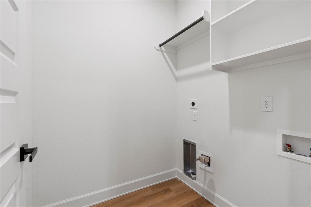 6321 Foster Street Houston, TX 77021 - Photo 18 of 19 Spacious laundry room with convenient hookups, shelving, and a sleek modern design.
