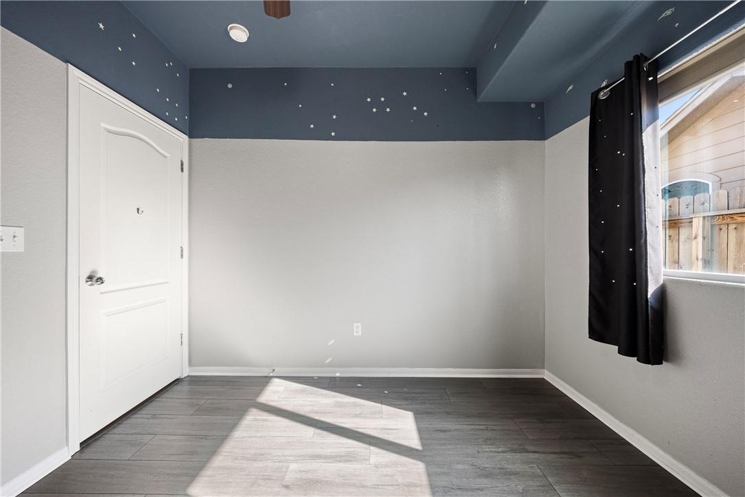 1022 Imperial Street Portland, TX 78374 - Photo 12 of 16 an empty room with wooden floor and windows