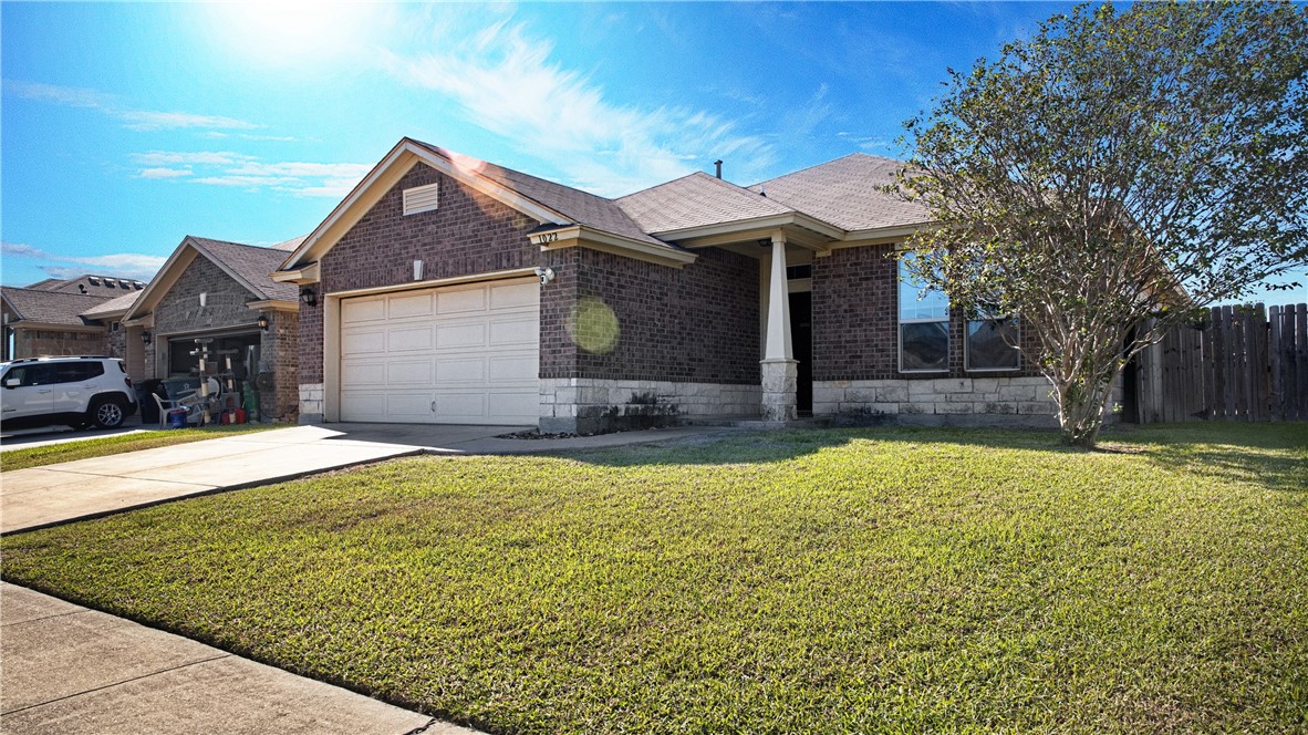 1022 Imperial Street Portland, TX 78374 - Photo 2 of 16 a front view of house with yard and trees in the background