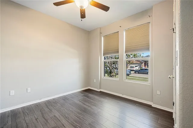 wooden floor in an empty room with a window