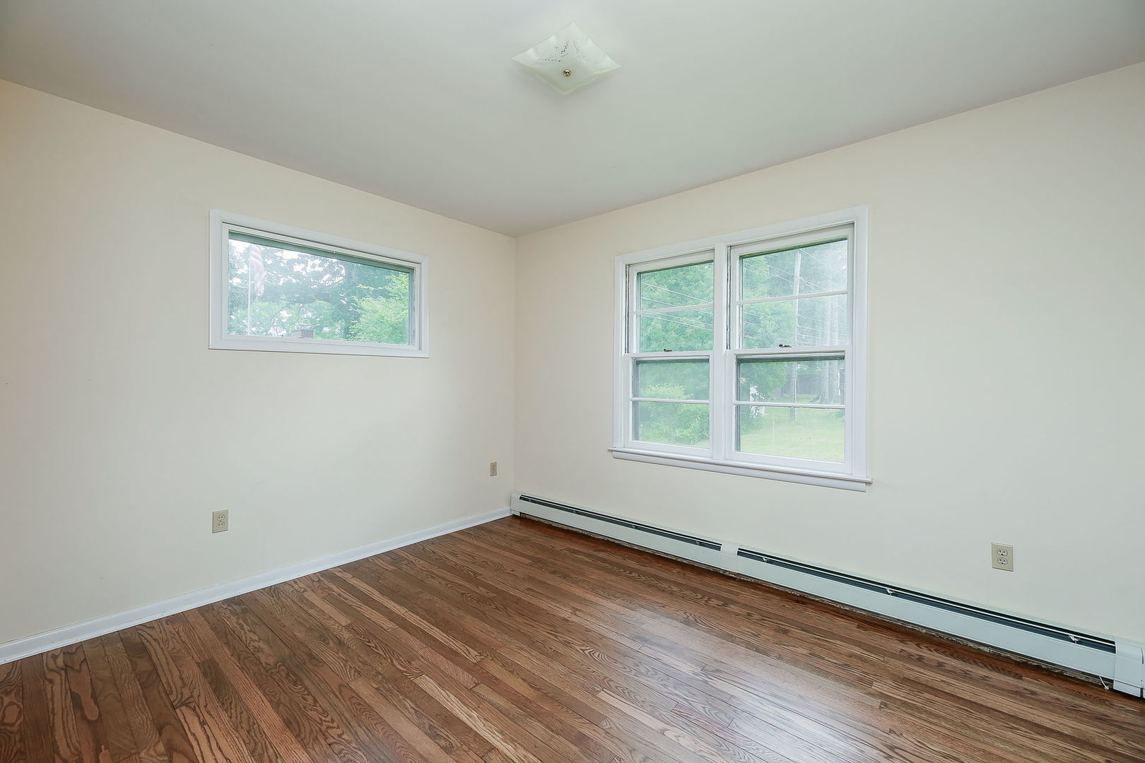 1170 South Broadway Road Montgomery, IL 60538 - Photo 17 of 25 an empty room with wooden floor and windows