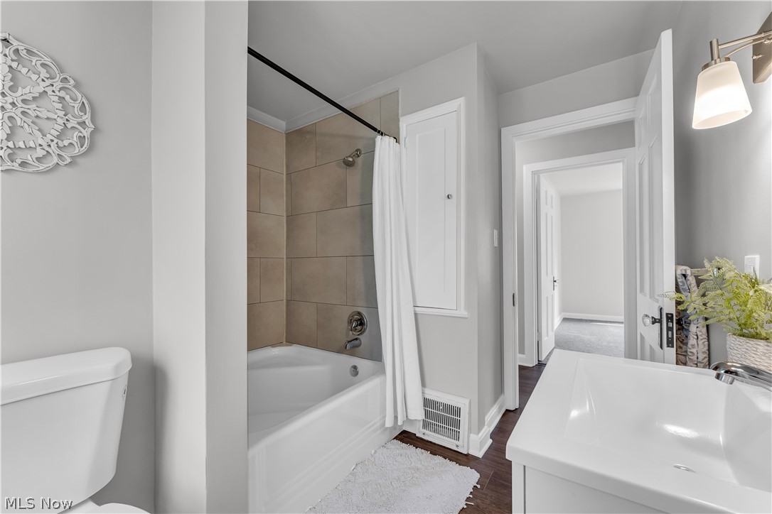 1539 Sunview Road Cleveland, OH 44124 - Photo 28 of 38 Full bathroom featuring shower / bath combination with curtain, vanity, hardwood / wood-style flooring, and toilet
