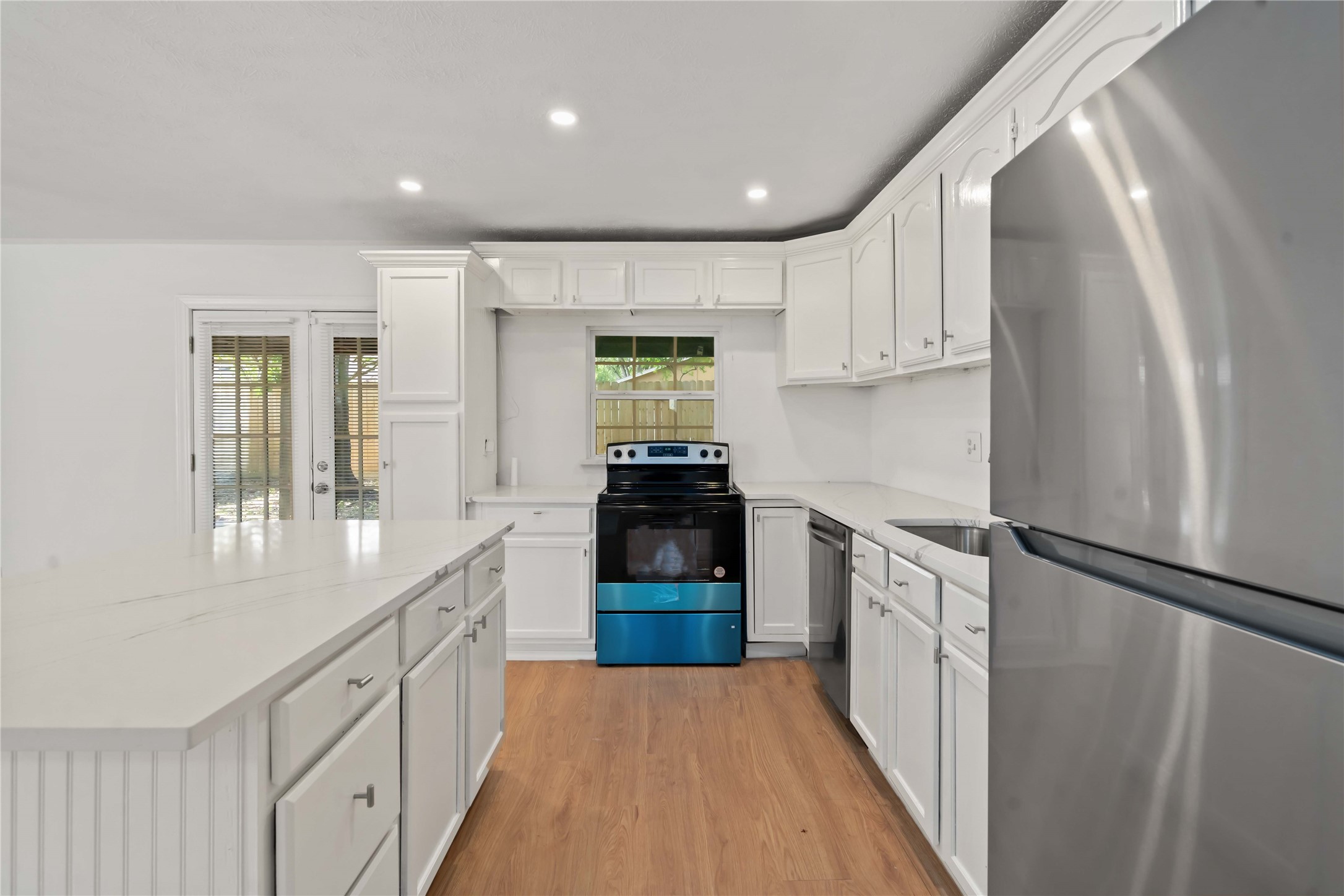17415 North Barker Street Houston, TX 77084 - Photo 14 of 30 a kitchen with granite countertop a refrigerator and a stove top oven