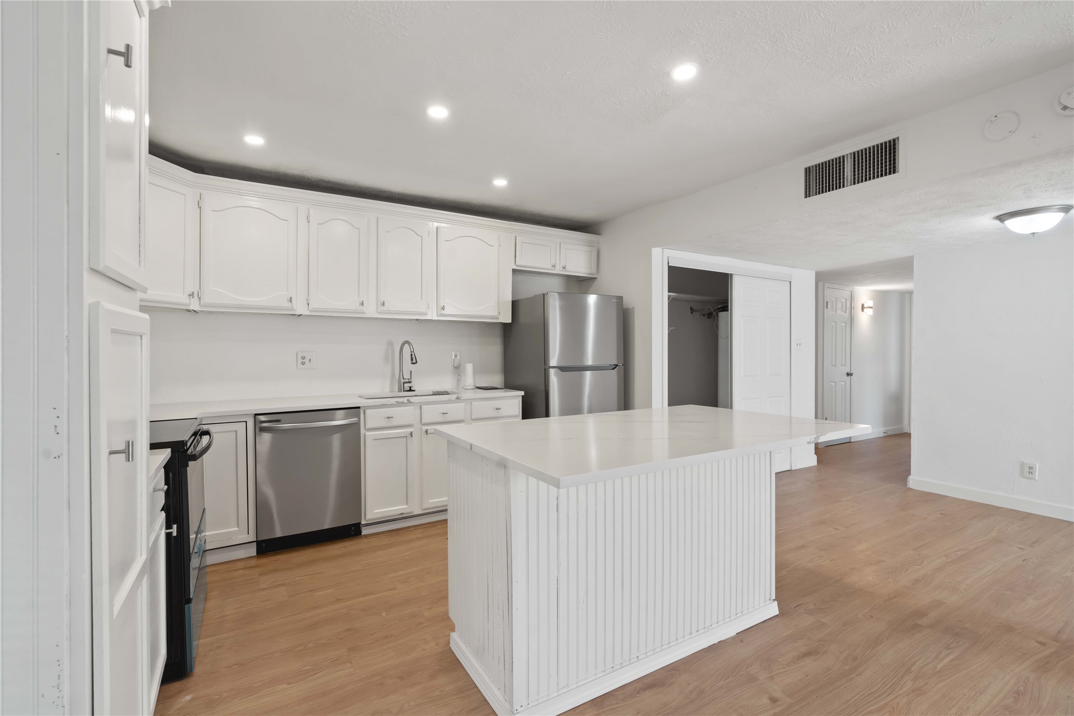 17415 North Barker Street Houston, TX 77084 - Photo 15 of 30 a large white kitchen with stainless steel appliances granite countertop a stove a refrigerator a sink and a refrigerator