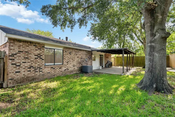 a view of a house with backyard and sitting area