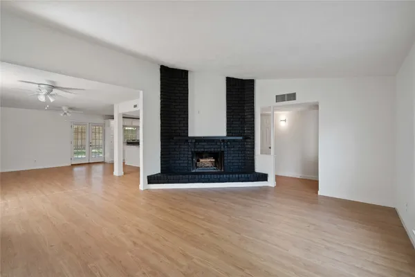 wooden floor fireplace and natural light in room