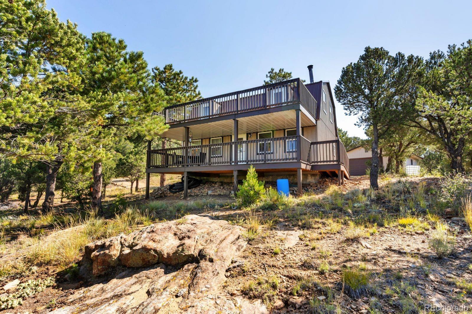 570 Rocky Ridge Road Westcliffe, CO 81252 - Photo 1 of 33 a view of a back yard of the house