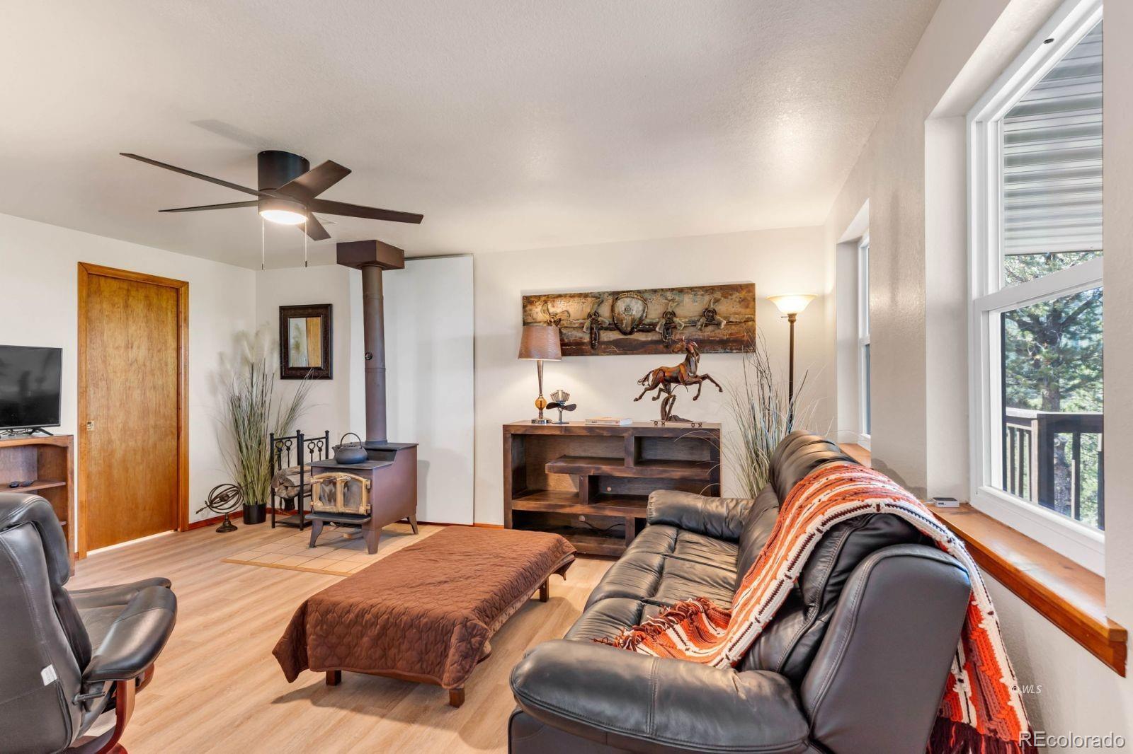 570 Rocky Ridge Road Westcliffe, CO 81252 - Photo 11 of 33 a bedroom with furniture and a chandelier