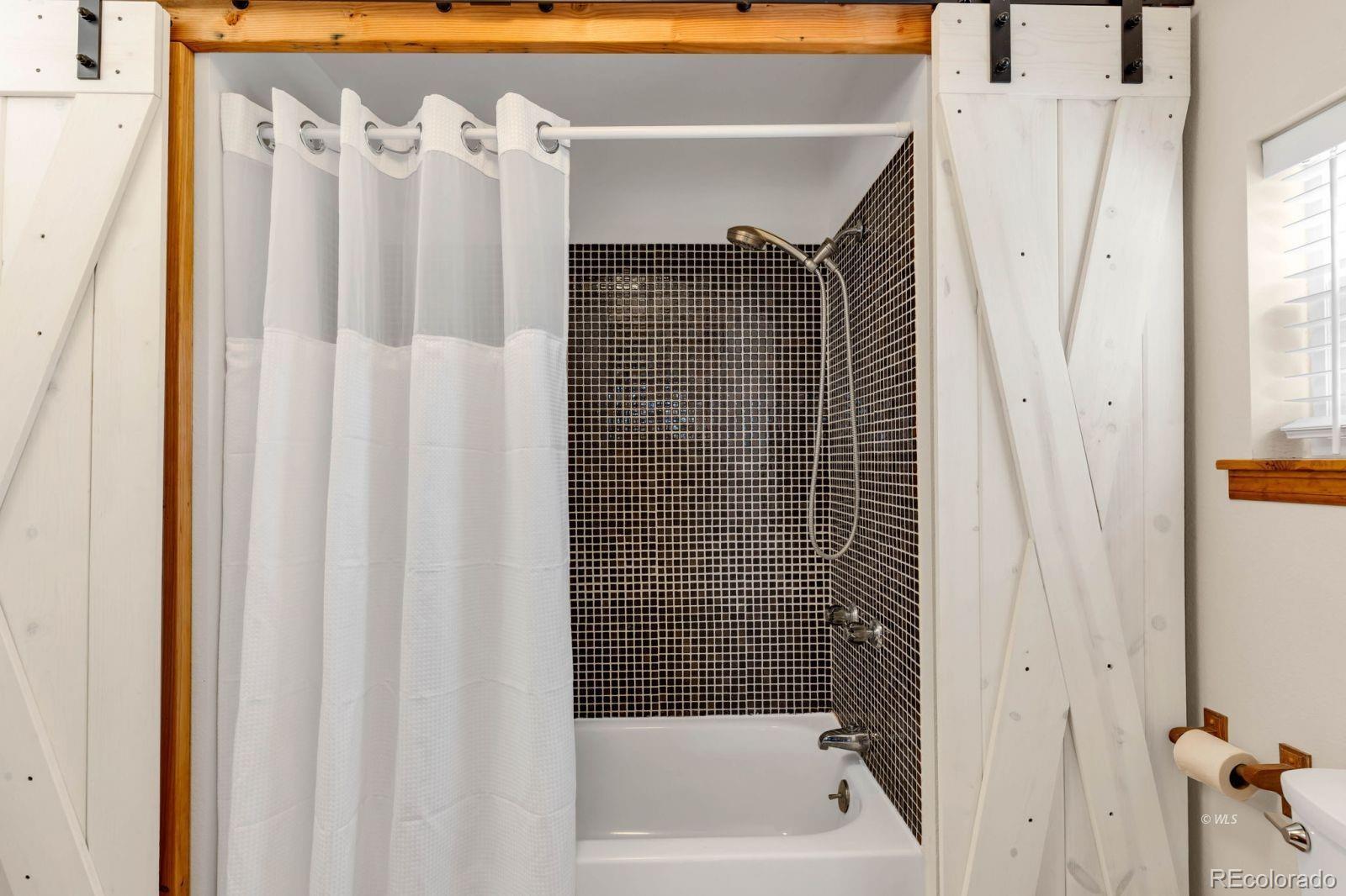 570 Rocky Ridge Road Westcliffe, CO 81252 - Photo 14 of 33 a bathroom with a shower curtain and a sink