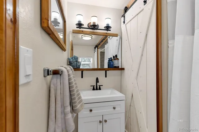 a bathroom with a sink a mirror and shower