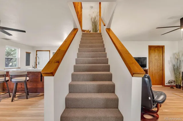a living room with furniture and stairs