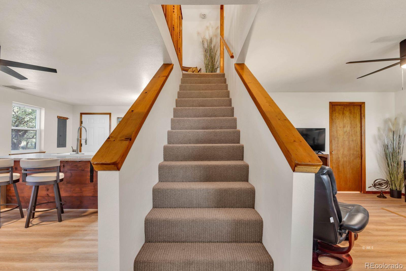 570 Rocky Ridge Road Westcliffe, CO 81252 - Photo 17 of 33 a living room with furniture and stairs