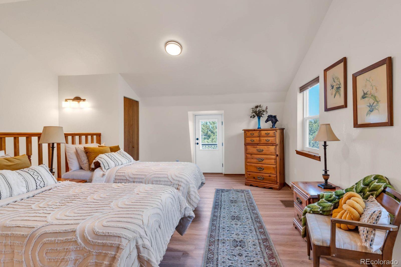 570 Rocky Ridge Road Westcliffe, CO 81252 - Photo 19 of 33 a bed room with a bed and a chair