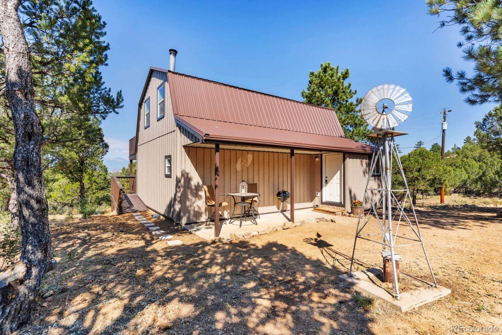 570 Rocky Ridge Road Westcliffe, CO 81252 - Photo 3 of 33 a view of a chairs and tables in the patio