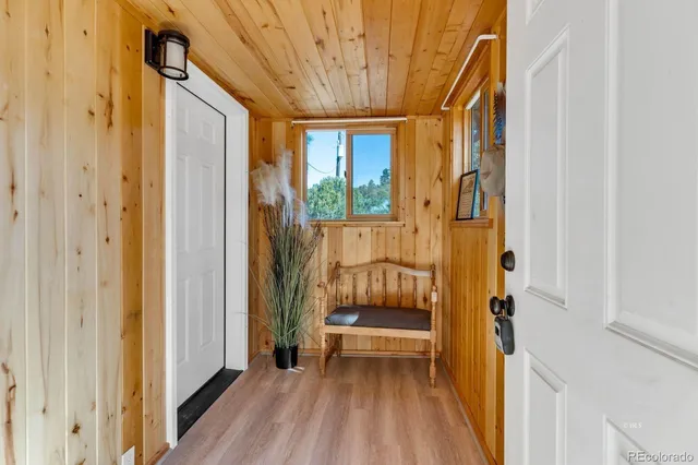 a view of entryway with wooden floor and door