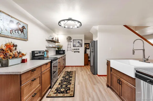 a kitchen with a refrigerator a stove top oven a sink and dishwasher