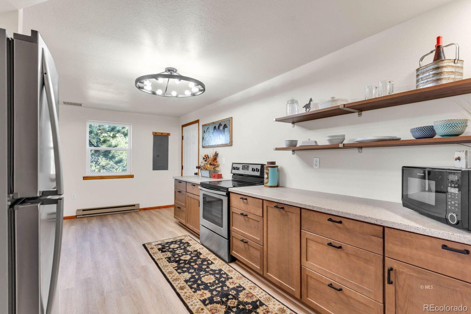 570 Rocky Ridge Road Westcliffe, CO 81252 - Photo 7 of 33 a kitchen with stainless steel appliances a lot of counter space and cabinets