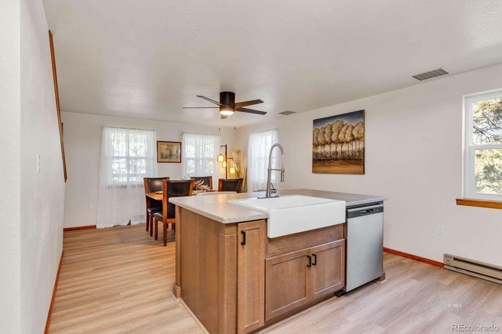 570 Rocky Ridge Road Westcliffe, CO 81252 - Photo 8 of 33 a view of a kitchen counter space a sink wooden floor and a window