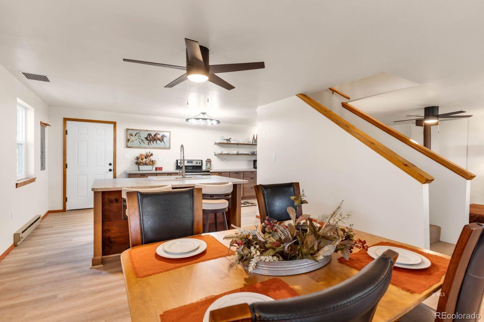 570 Rocky Ridge Road Westcliffe, CO 81252 - Photo 10 of 33 a kitchen with stainless steel appliances granite countertop a sink a stove a dining table and chairs