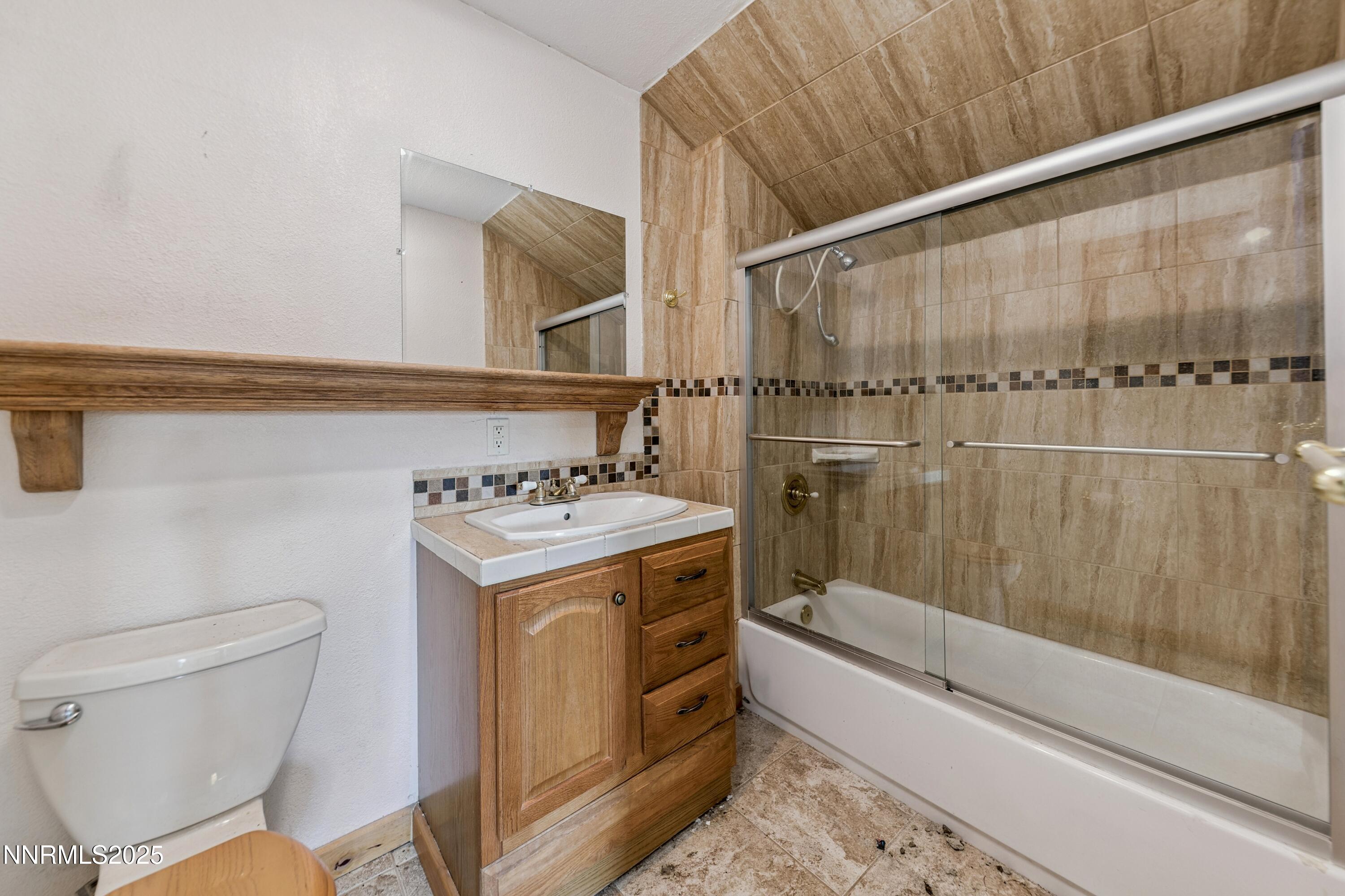 21565 Dortort Drive Reno, NV 89521 - Photo 14 of 25 a bathroom with a sink a toilet and shower