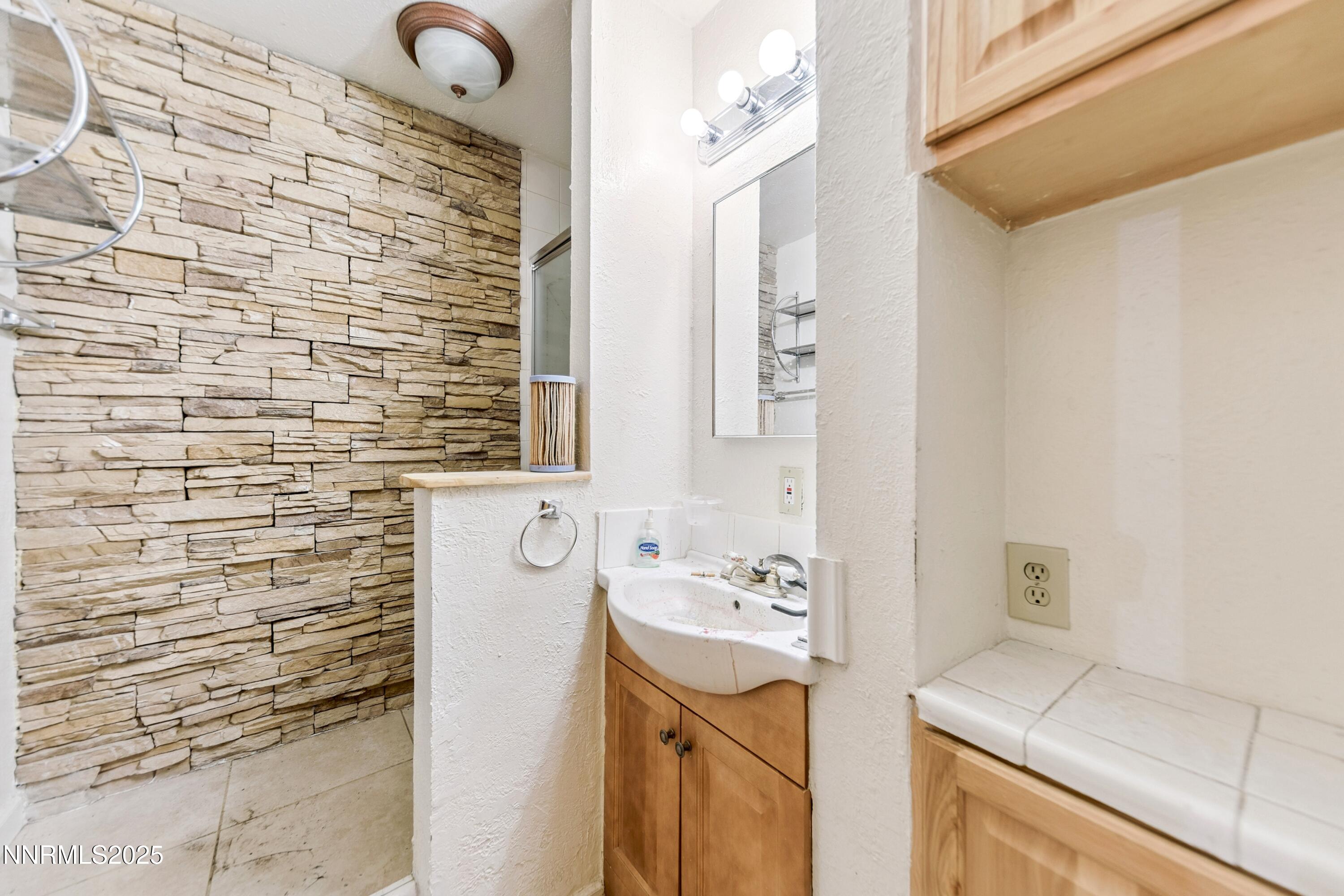 21565 Dortort Drive Reno, NV 89521 - Photo 19 of 25 a bathroom with a sink and a mirror