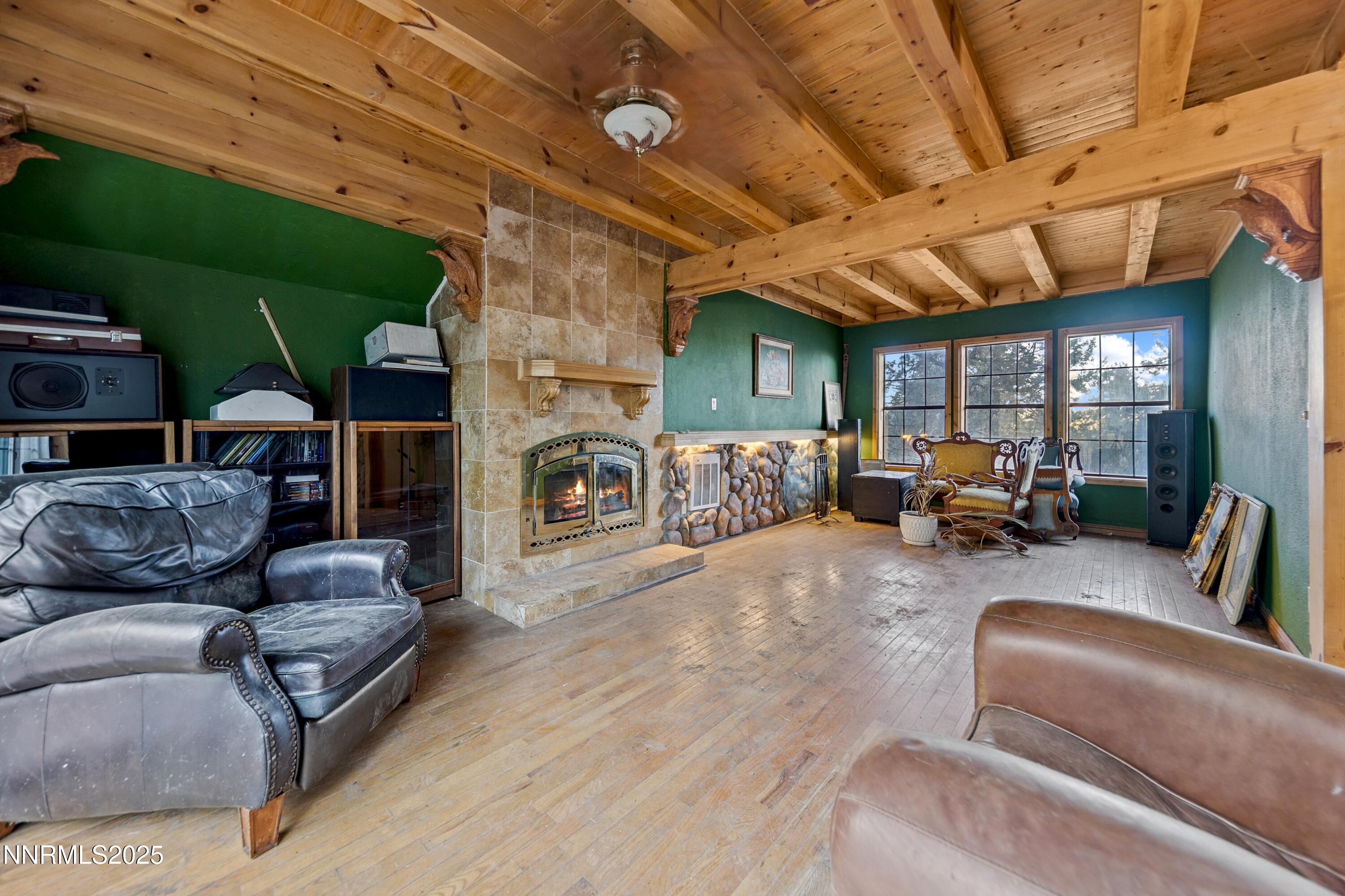 21565 Dortort Drive Reno, NV 89521 - Photo 21 of 25 a living room with furniture a fireplace and a wooden floor