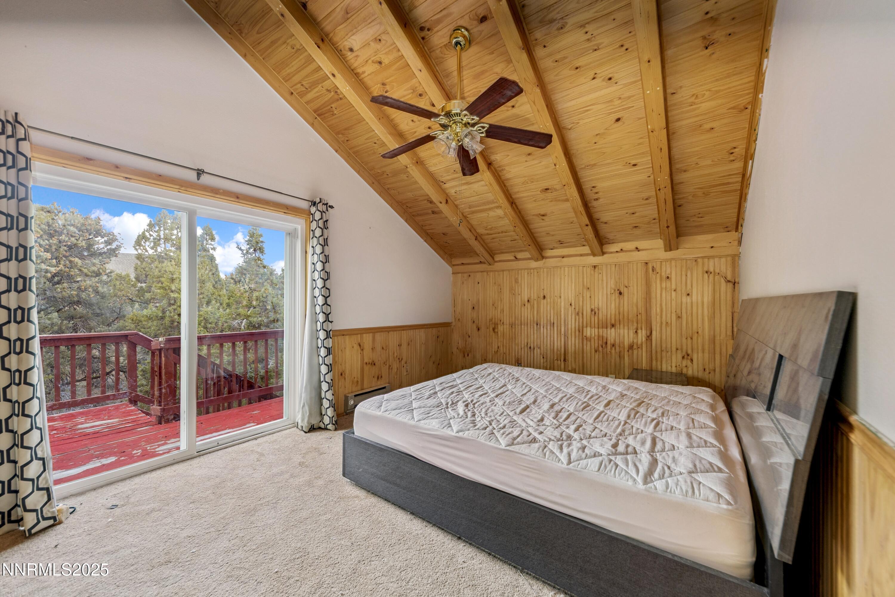 21565 Dortort Drive Reno, NV 89521 - Photo 23 of 25 a bedroom with a bed and large window with balcony view