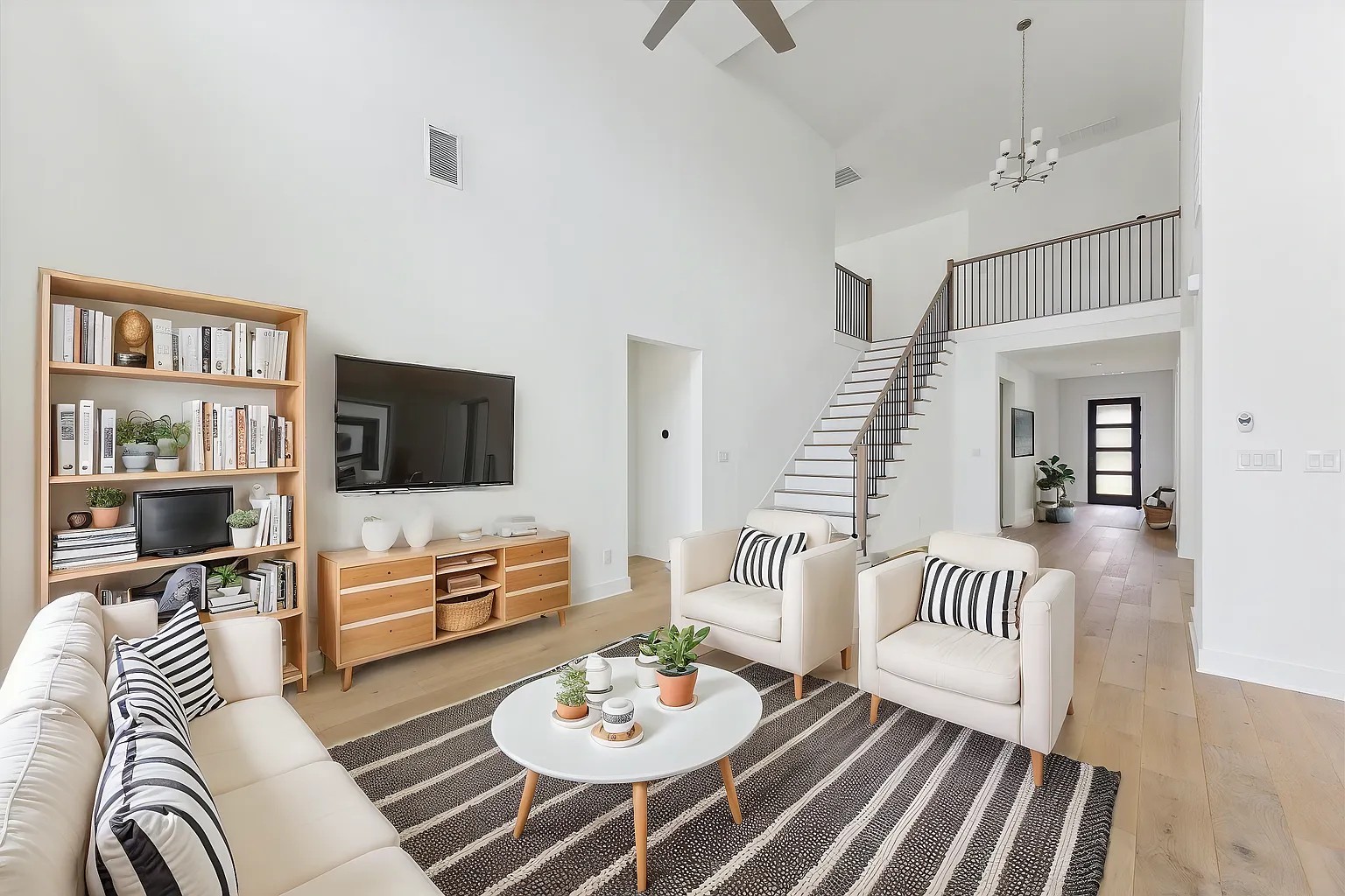 1909 Varese Path Leander, TX 78641 - Photo 9 of 40 Soaring ceilings create an airy atmosphere in this modern living space with gleaming hardwood floors.