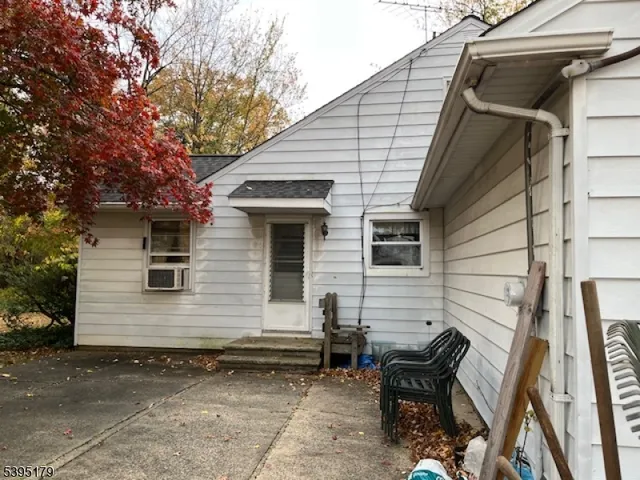 a view of a two chairs and table in the back yard