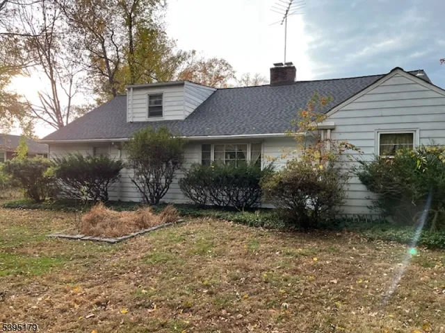 a view of a house with a small yard and plants