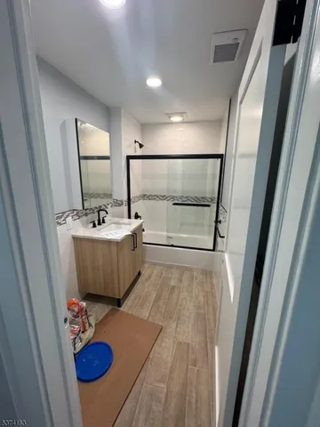a view of a bathroom with a sink mirror and bathtub