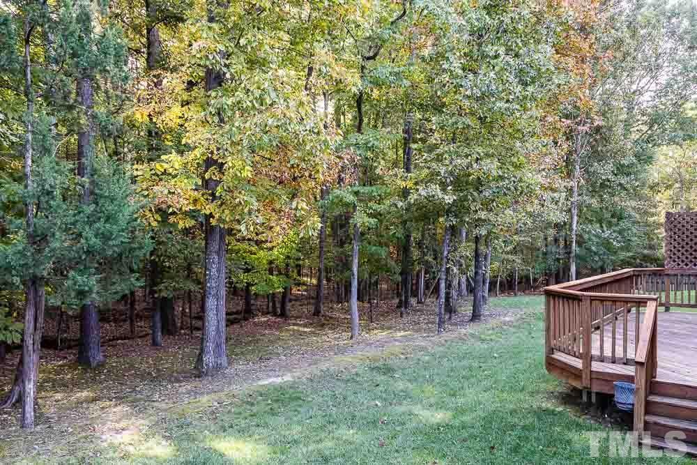 8236 Clarks Branch Drive Raleigh, NC 27613 - Photo 22 of 25 a view of outdoor space with a wooden fence and a bench