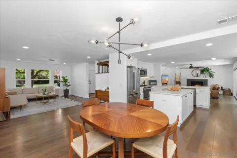a large kitchen with a table and chairs