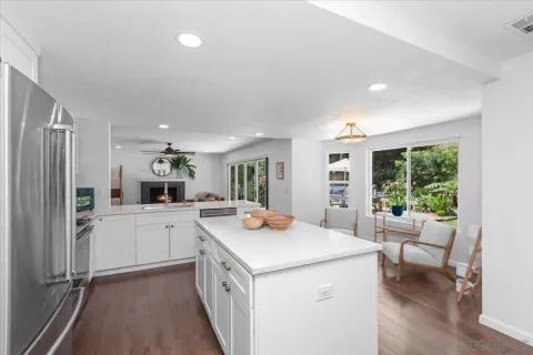 a view of kitchen with sink and refrigerator