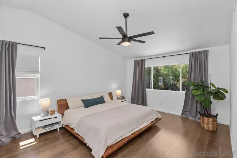 a bedroom with a bed and a potted plant