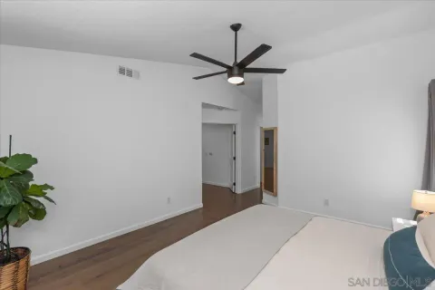 a bedroom with a bed and a potted plant