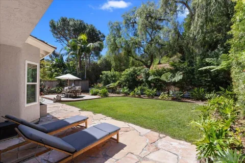 a view of a backyard with sitting area