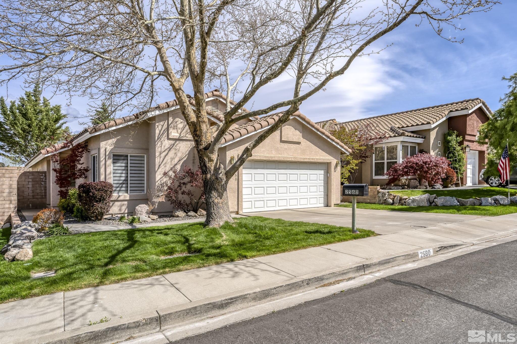 2560 Granite Springs Road Reno, NV 89519 - Photo 1 of 33 a front view of a house with a yard and garage
