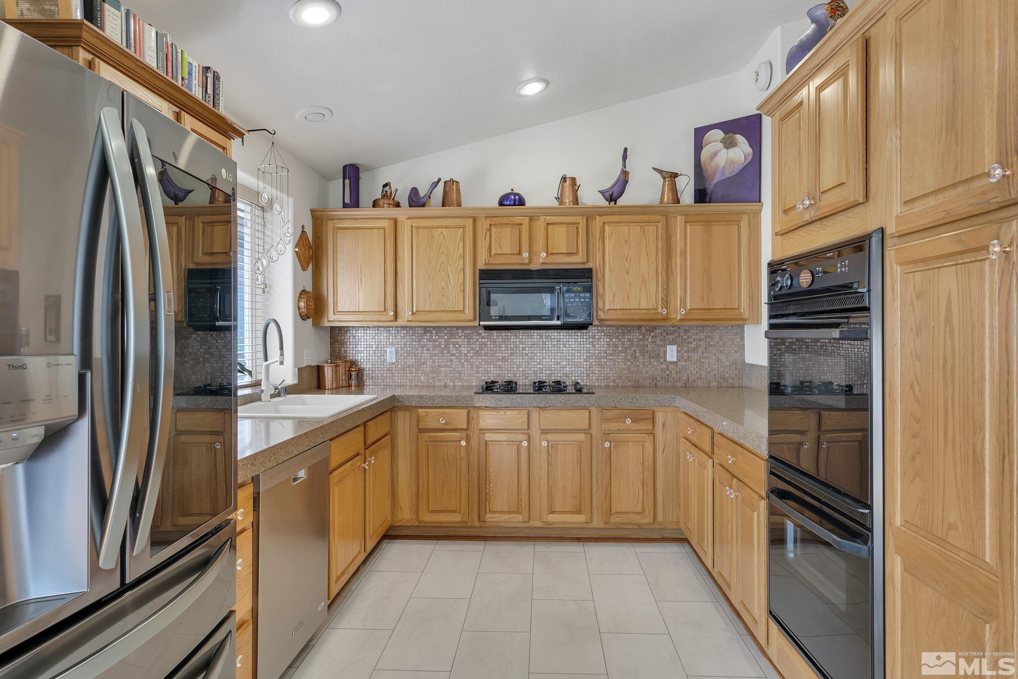 2560 Granite Springs Road Reno, NV 89519 - Photo 13 of 33 a kitchen with stainless steel appliances granite countertop a refrigerator and a sink
