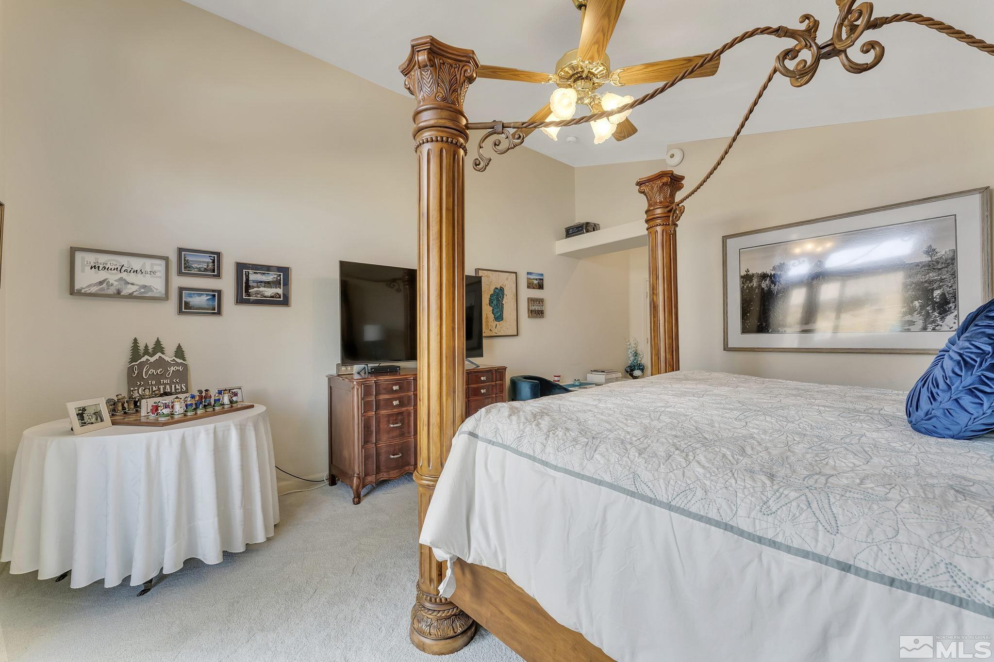 2560 Granite Springs Road Reno, NV 89519 - Photo 17 of 33 a spacious bedroom with a bed and a flat screen tv