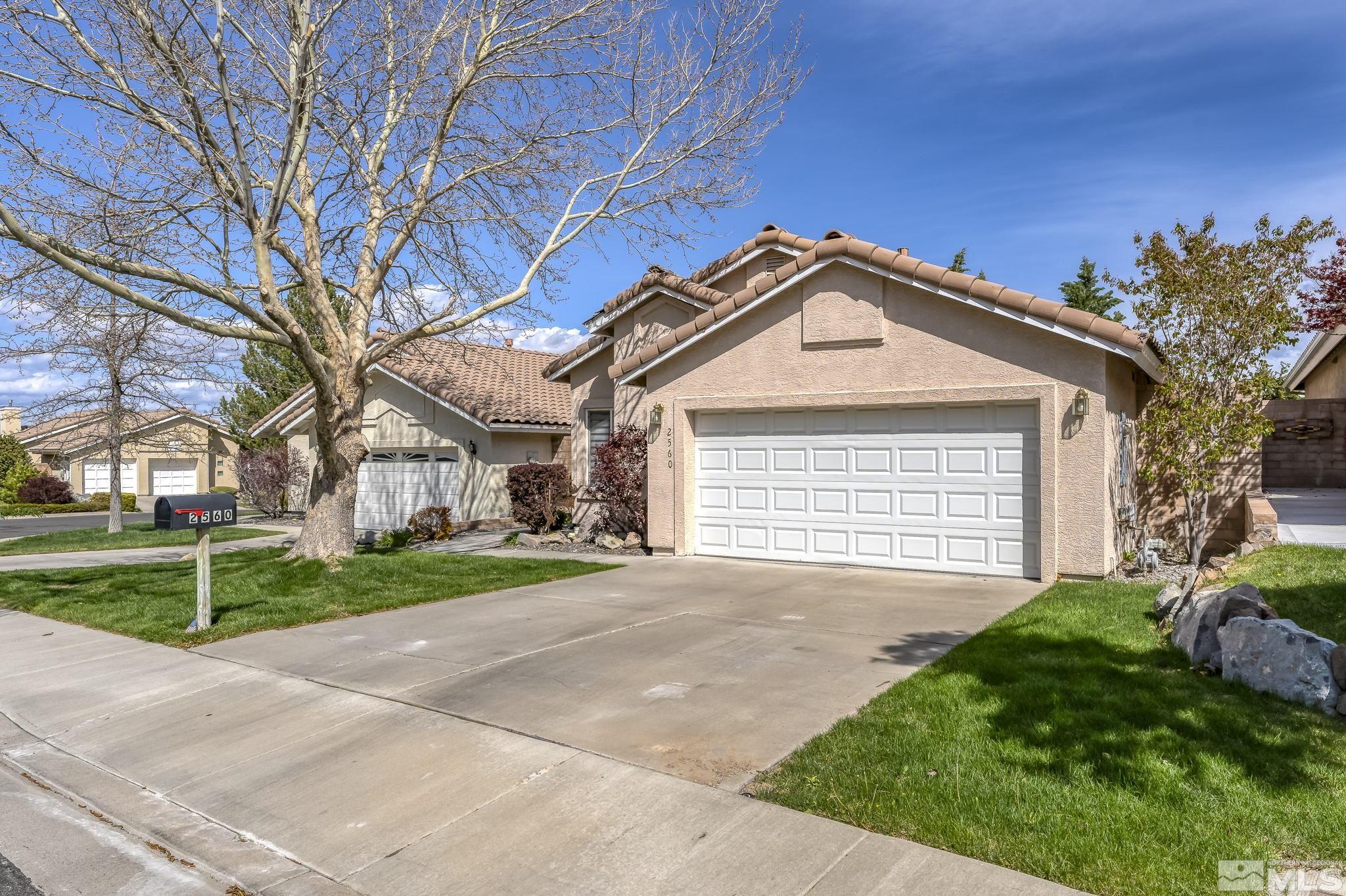2560 Granite Springs Road Reno, NV 89519 - Photo 3 of 33 a front view of a house with a yard and garage