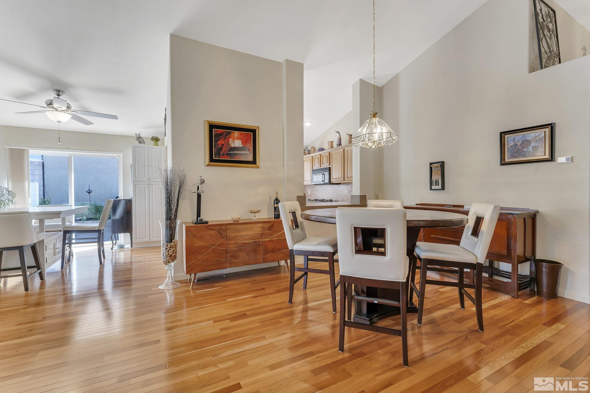 2560 Granite Springs Road Reno, NV 89519 - Photo 6 of 33 a dining room with furniture wooden floor a rug and a painting