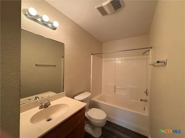 a bathroom with a sink mirror toilet and bathtub