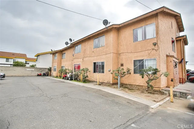 a backyard of a house with table and chairs
