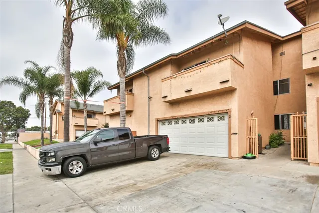a view of a street with cars parked in front of it