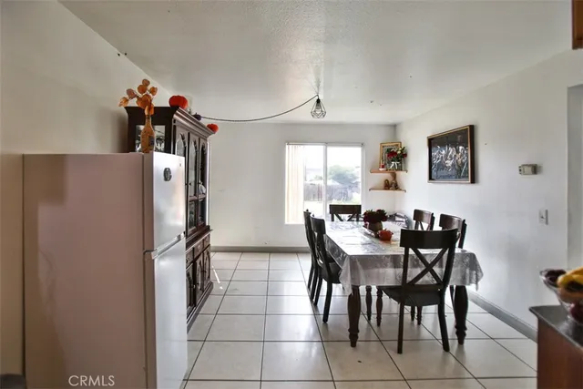 a view of a dining room with furniture a chandelier and wooden floor