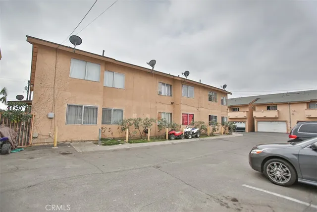 a front view of a house with a parking space